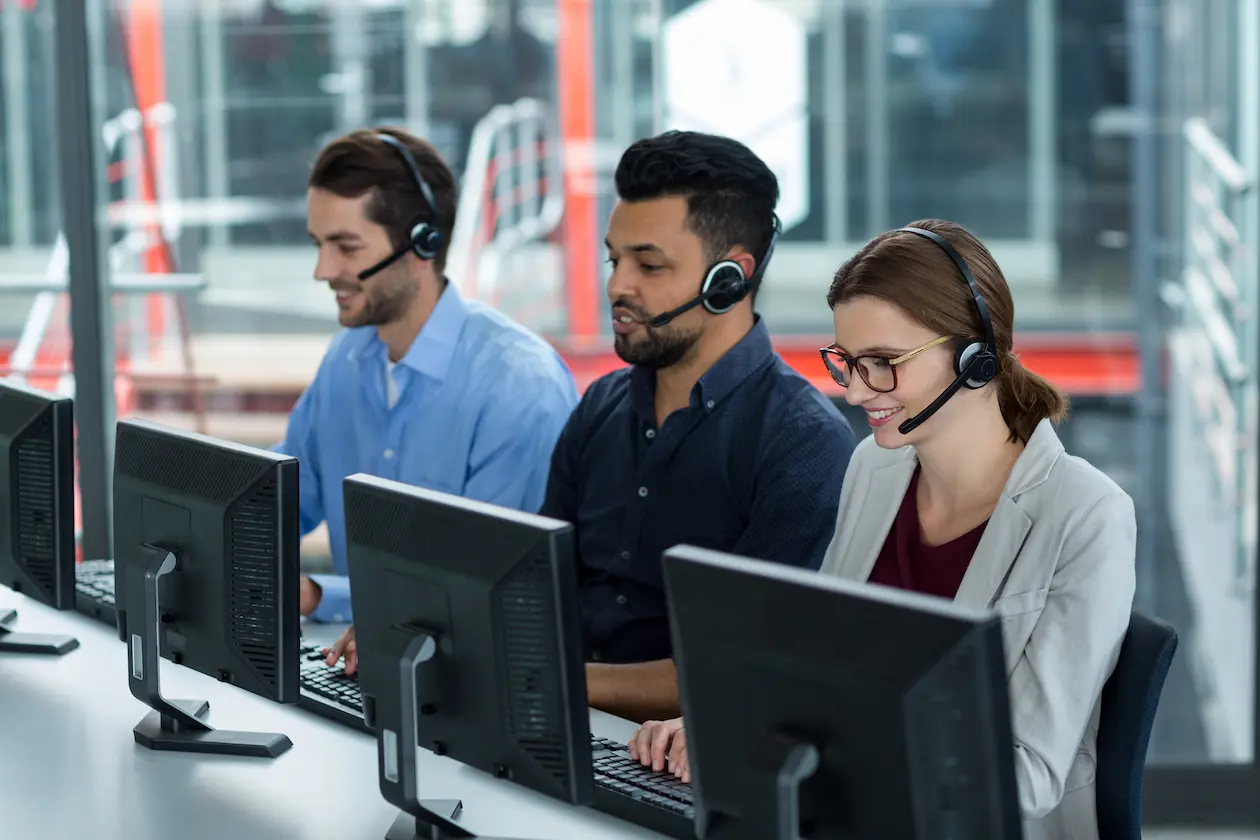 Dedicated customer support professionals working in a modern office