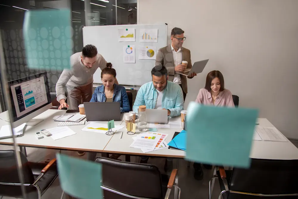 A marketing team reviewing campaign requirements in a collaborative meeting